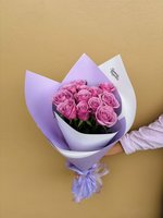 Rachel bouquet featuring fourteen fresh pink roses with green foliage, elegantly wrapped in purple and white decorative paper with a matching ribbo...