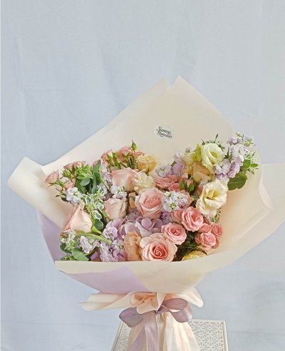 Elegant bouquet of pink roses, lisianthus, stock, and hydrangeas with eucalyptus. Perfect for romantic occasions. Phuket flowers for special moments.